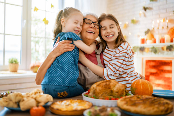 Happy Thanksgiving Day Happy Thanksgiving Day! Autumn feast. Family sitting at the table and celebrating holiday. Traditional dinner. Grandmother and granddaughters. luck photos stock pictures, royalty-free photos & images