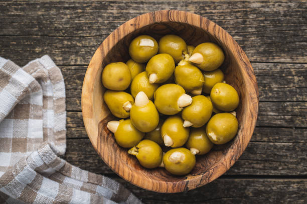 pitted green olives stuffed with almonds. - olive green olive stuffed food imagens e fotografias de stock