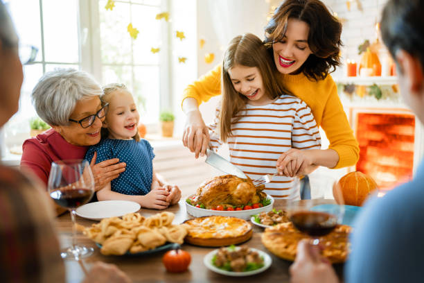 Happy Thanksgiving Day Happy Thanksgiving Day! Autumn feast. Family sitting at the table and celebrating holiday. Grandparents, mother, father and children. Traditional dinner. thanksgiving stock pictures, royalty-free photos & images