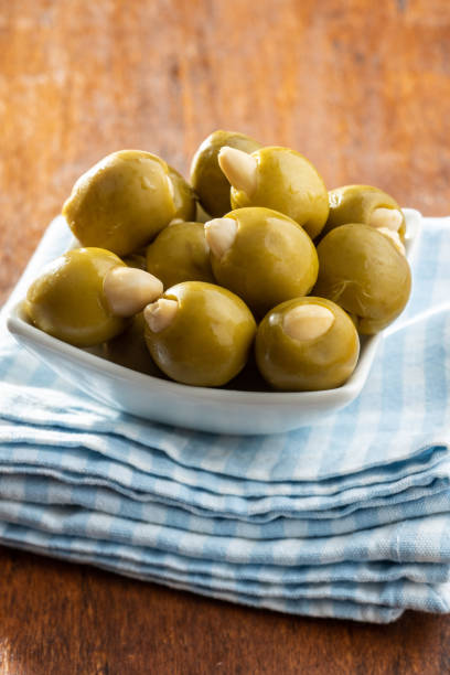 istock Pitted green olives stuffed with almonds. 1282434693