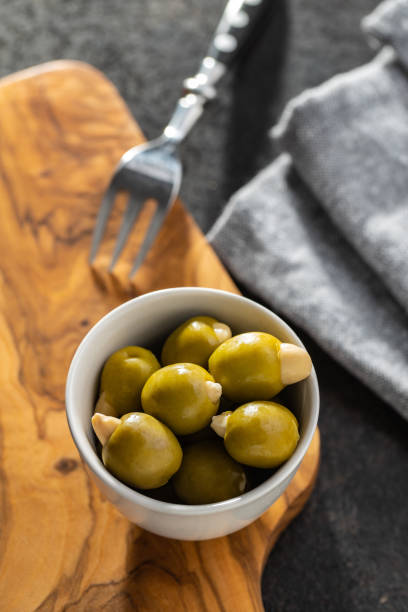 istock Pitted green olives stuffed with almonds. 1282434701