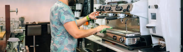 istock Young waiter cleaning the coffee machine 1282439515