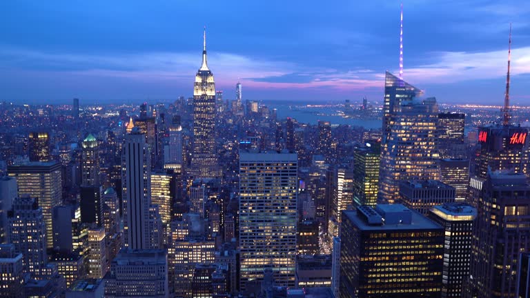 Tilt Up: High angle view of Manhattan NYC New York sunset. American lifestyle cityscape Lanmark and tourism concept.