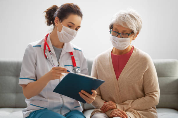 istock Doctor and senior woman wearing facemasks 1282441026