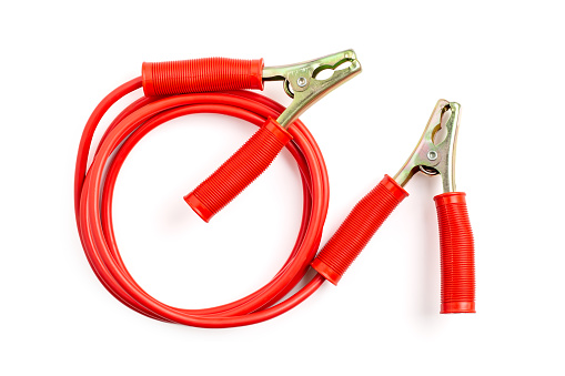 Red color battery extension cable or booster cable isolated on white background.