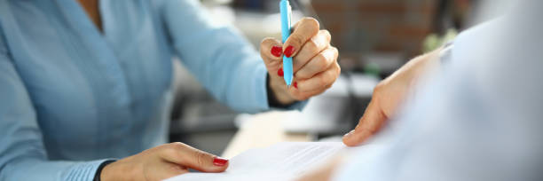 istock Successful woman signs documents in office closeup 1282441382