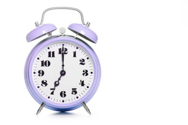 istock Classic purple table alarm clock on a white background 1282441484