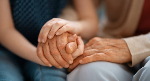 Granddaughter supporting her grandmother Granddaughter supporting her grandmother. Hands close up. legacy concept stock pictures, royalty-free photos & images