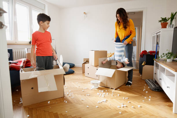 istock Mother playing with sons during house move in a messy room with boxes 1282442572