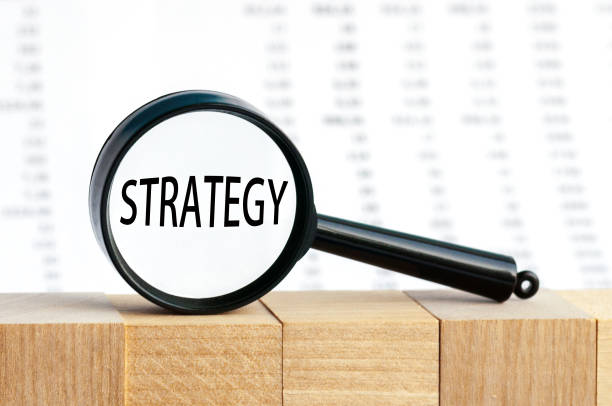 istock Look closely and STRATEGY with a magnifying glass , business concept image with soft focus background 1282443519
