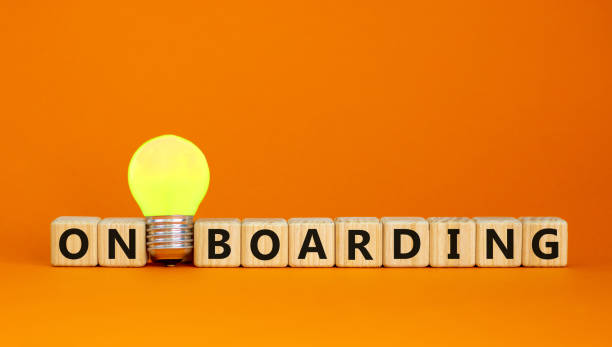 Wooden cubes with word 'onboarding'. Yellow light bulb. Beautiful orange background. Business concept. Copy space. Wooden cubes with word 'onboarding'. Yellow light bulb. Beautiful orange background. Business concept. Copy space. new hire stock pictures, royalty-free photos & images