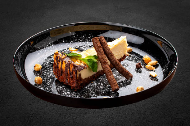 istock Cheesecake with nuts and chocolate tubes. On a decorative plate 1282445655