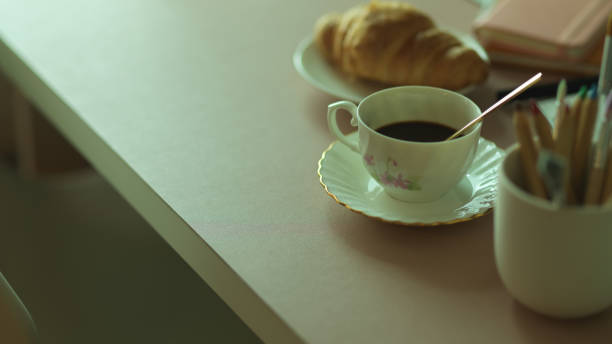 istock Breakfast meal with coffee cup and croissant on workspace 1282445793