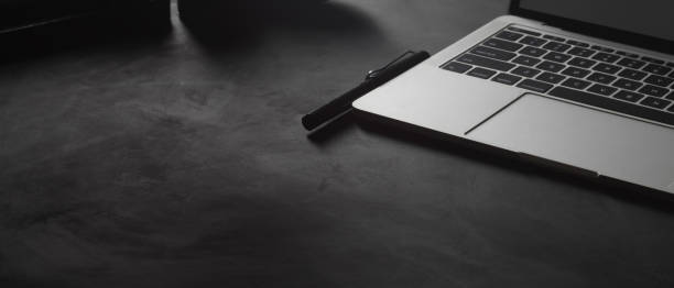 istock Black table with laptop, supplies and copy space 1282448044