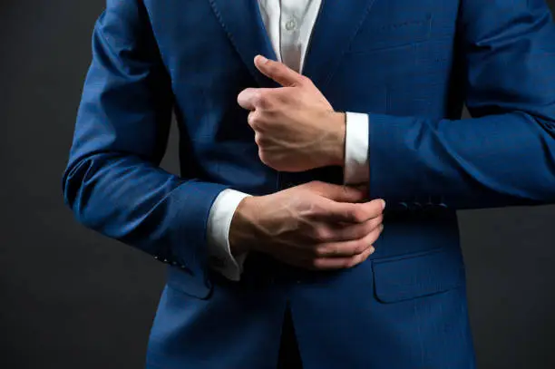 Correct sleeve length. Every detail matters. Jacket perfect fit. Business style formal dress code. Male hands adjusting business suit close up. Formal style. Business people choose formal clothing.