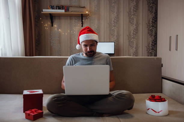 istock A hipster man with a red cup sitting at home at Christmas time. 1282451529