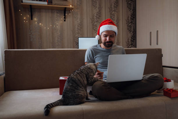 istock A hipster man with a red cup sitting at home at Christmas time. 1282451610