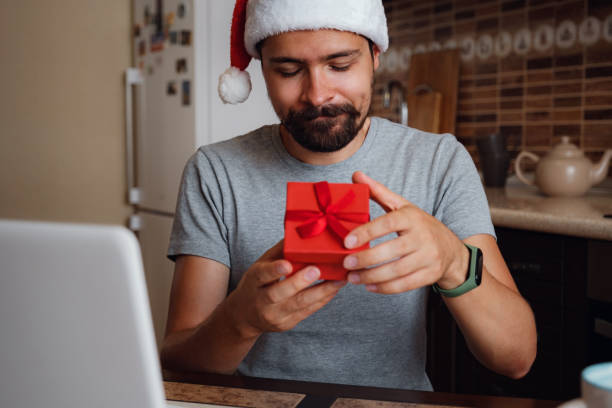 istock A hipster man with a red cup sitting at home at Christmas time. 1282451652