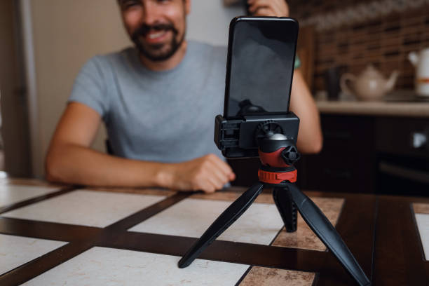 istock Young man having video call via smartphone in the home office. 1282451931