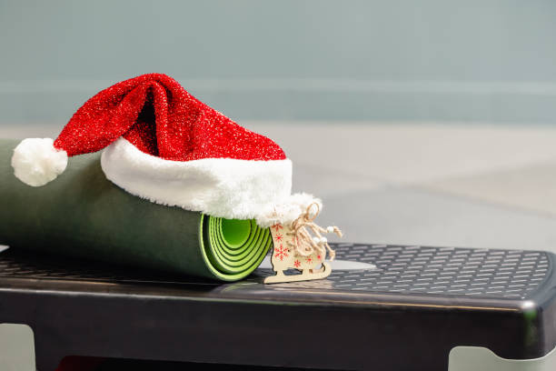 mat with Santa Clause hat at gym stock photo