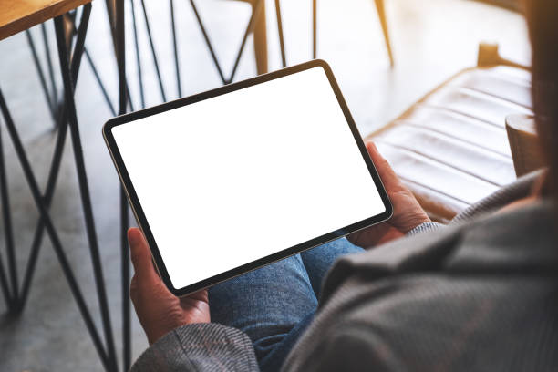 istock a woman holding digital tablet with blank white desktop screen 1282453958