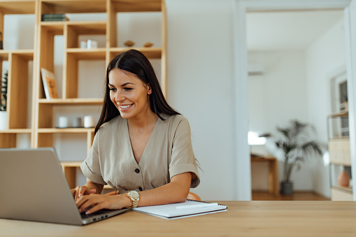 Woman sending an email to someone.