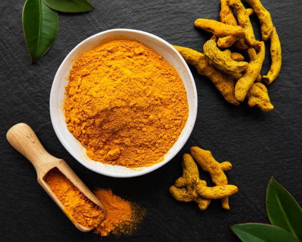 istock Turmeric powder and dry roots 1282454393