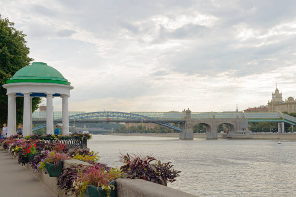 Panorama of Moscow River,  Raushskaya Embankment, Moscow. GES-1 (Raushskaya Power Station), oldest in Russia (1897). UNESCO. Movement pleasure boats, blue cloudy sky. No recognizable people