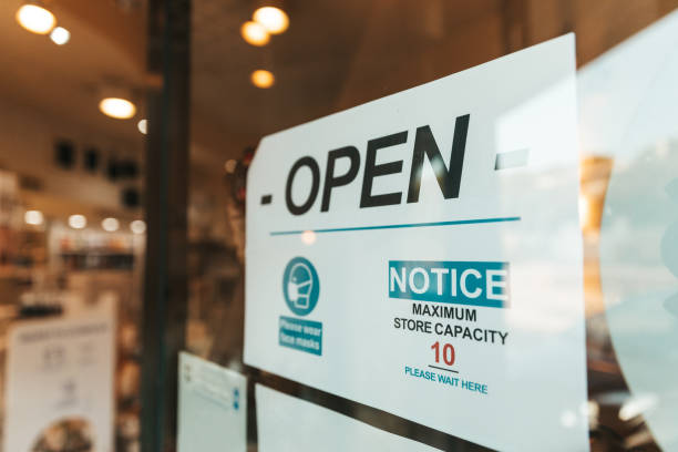 istock OPEN sign with safety measures to stop Covid-19 spread 1282455449