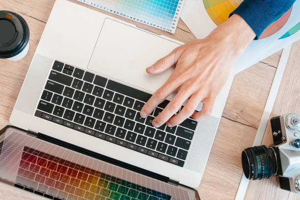 istock top view. designer using a laptop to work with the color palette 1282456801