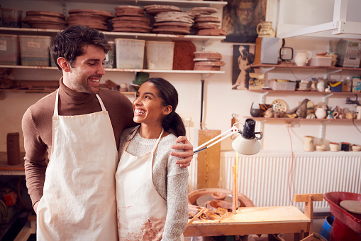 Couple Running Bespoke Pottery Business Working In Ceramics Studio Together