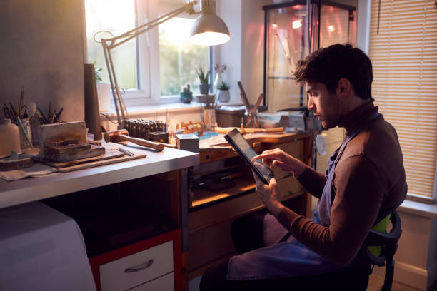 istock Male Jeweller Looking At Ring Design On Digital Tablet In Studio 1282456928