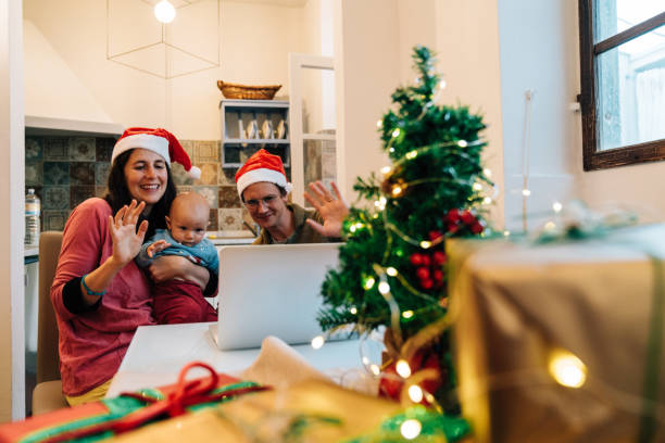 istock Family celebrating Christmas doing a video call with their relatives 1282457216