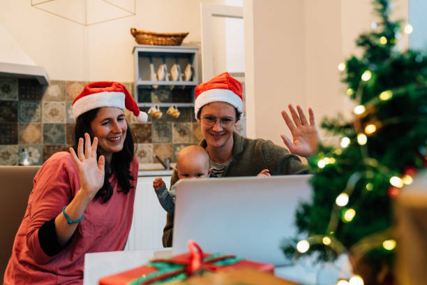istock Family celebrating Christmas doing a video call with their relatives 1282457220