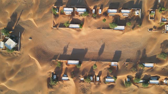 Aerial view of abandoned houses in the UAE desert near Dubai, overtaken by sand dunes
