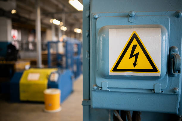 Yellow sigh danger electric shock with lightning in triangle on a metal electric distribution box. stock photo
