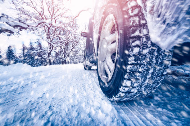 istock Car tires on winter road covered with snow 1282461334