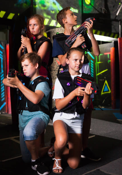 istock Girls and boys posing with laser pistols 1282462204