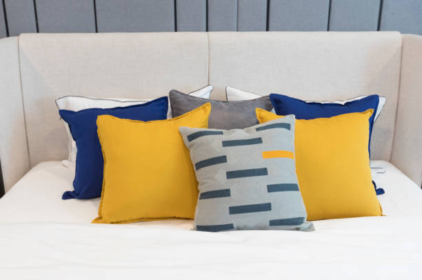 istock Stylish Bedroom with soft blue and yellow pillows setting on it. 1282462494