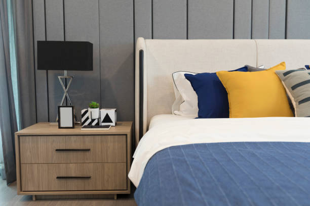 Stylish Bedroom with soft blue and yellow pillows setting on it.