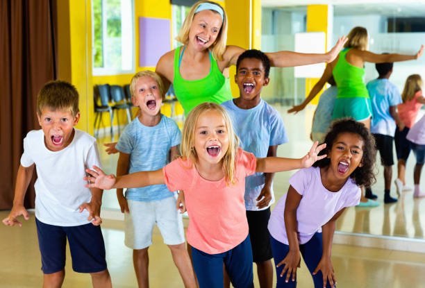 istock Happy tweens posing with young female coach during dance trainin 1282463655