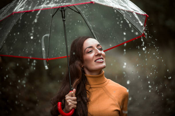 istock Beautiful young woman enjoying a rainy day 1282463885