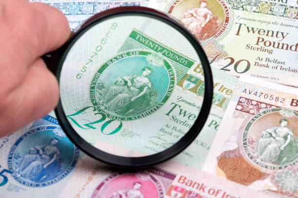 istock Northern Irish pounds in a magnifying glass 1282464244