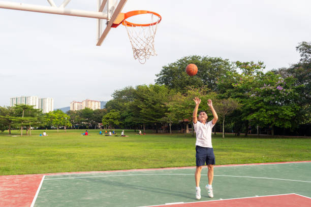 istock Senior basketball player throwing ball toward hoop 1282465101