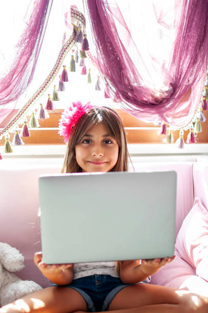 istock Littel girl using laptop at home 1282466067