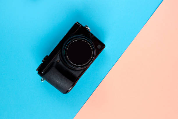 istock Flat lay of camera on blue and pink background 1282467946