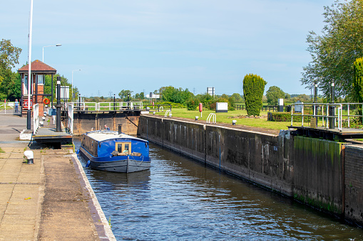 Cromwell Locks, UK - September 13th 2020: A barge moving up through the lock at Cromwell Locks on the River Trent in Nottinghamshire.