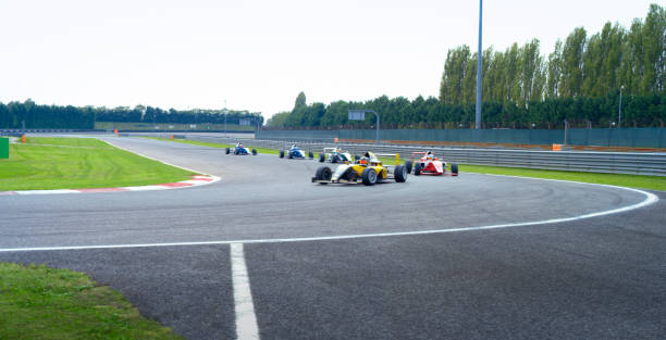 istock Racing drivers driving formula racing cars 1282470468