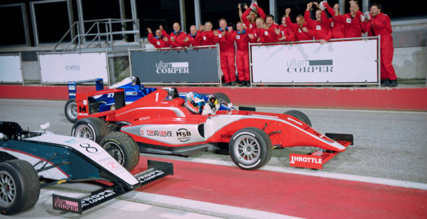Team members cheering driver at finishing line