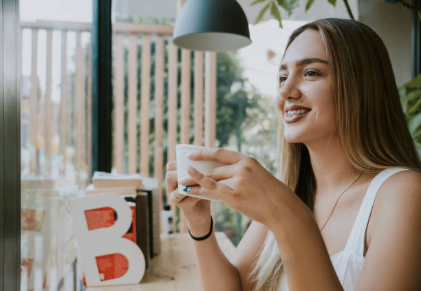 istock Beautiful woman is drinking coffee in cafe. 1282472301
